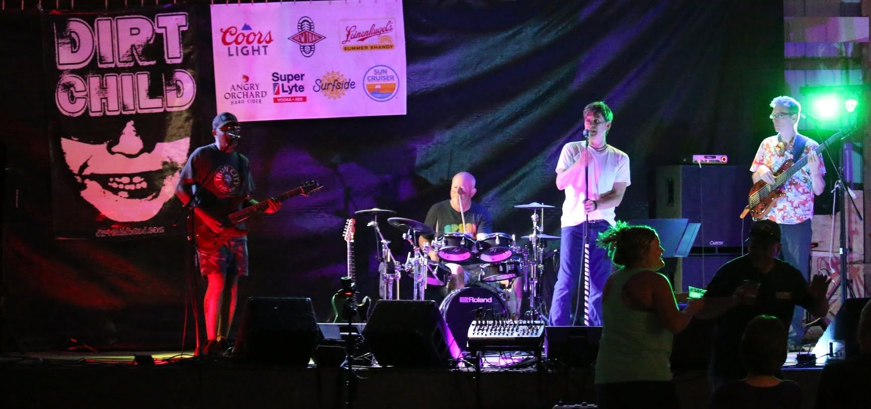 Dirt Child performing live on stage at the Yates County Fair beneath the Dirt Child banner